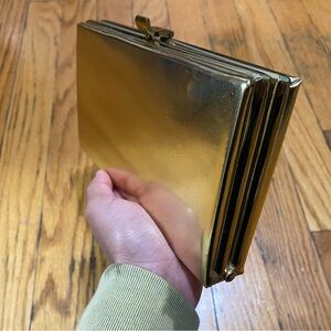 Gold, reflective boxy clutch